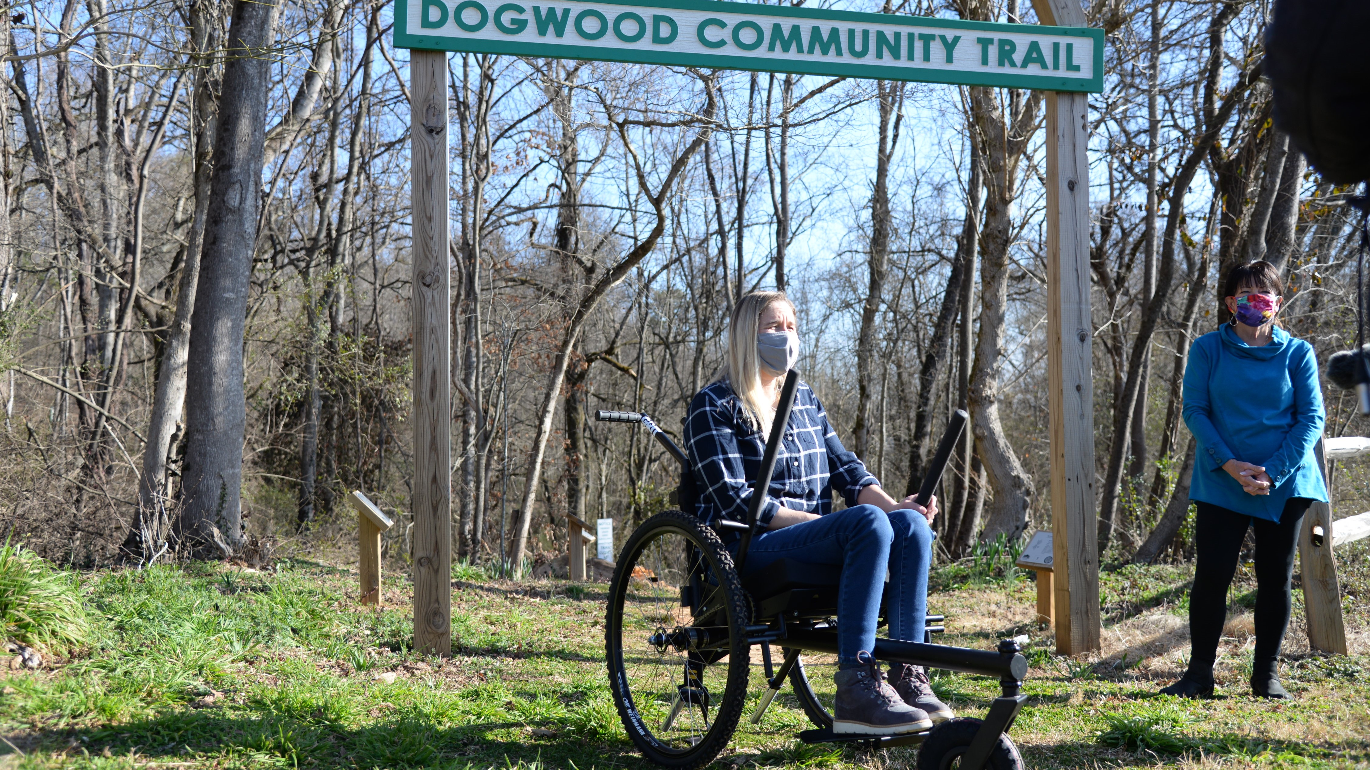 Carly Pearson demonstrates the GRIT Freedom Chair during an event at Dogwood Elementary School with Carol Evans, of Legacy Parks Foundation.